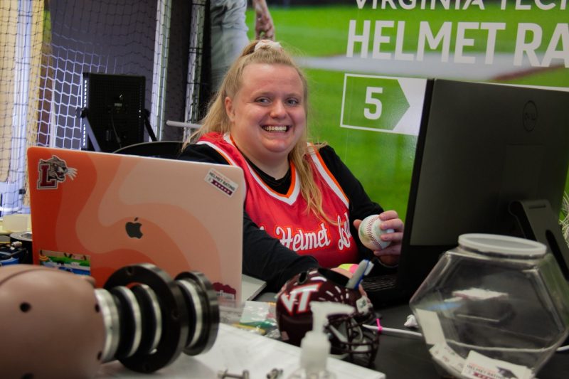 Kristin Dingelstedt Graduate student, Kristin Dingelstedt, working in the Helmet Lab. Kristin is working on her computer while holding a baseball. She is conducting research on helmets.